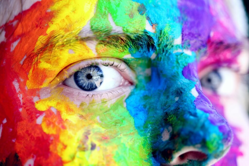 pexels-photo-1209843-1209843 Close-up of a person with colorful rainbow face paint, symbolizing LGBT pride and expression.