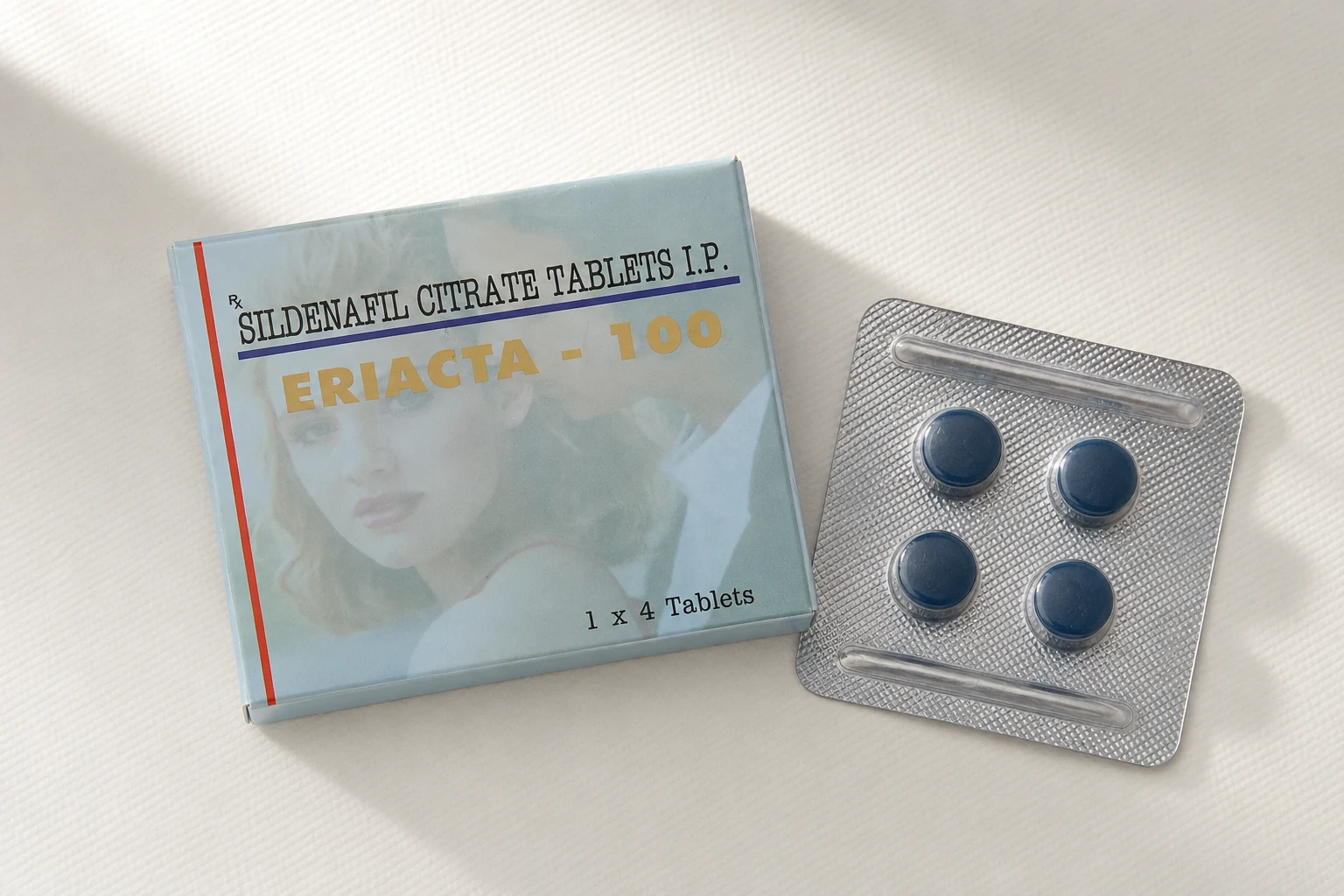 An Eriacta 100 carton and an intact blister containing four blue tablets on an ivory surface