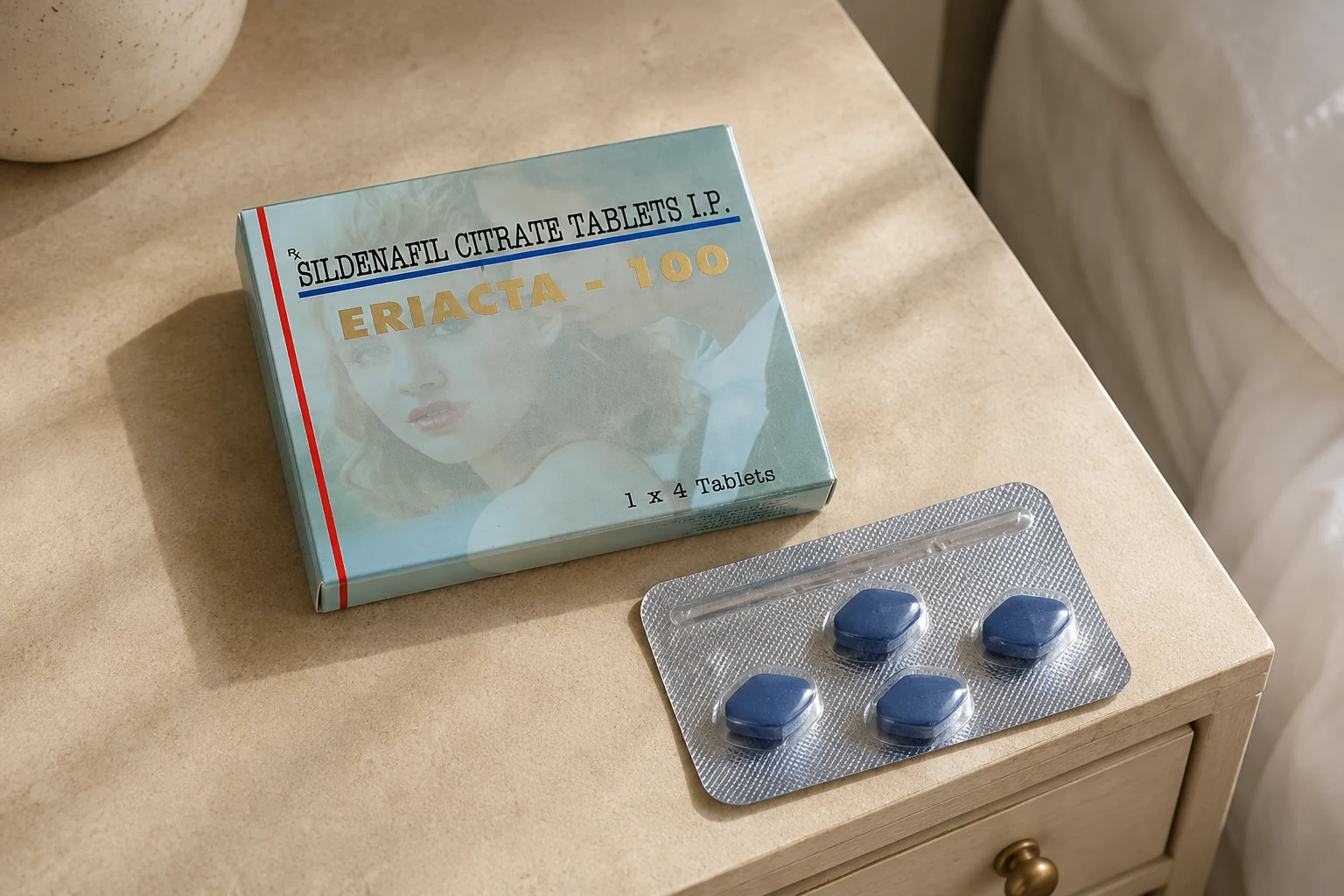 Eriacta 100 carton and a sealed four-tablet blister on a light bedside console