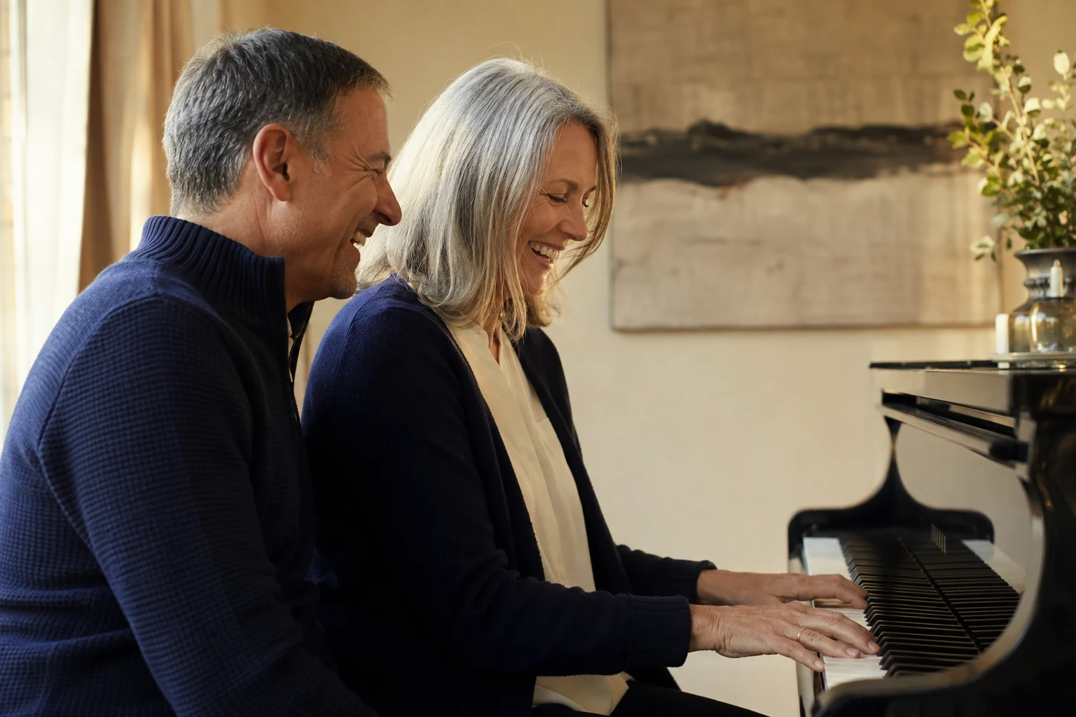 A mature couple sharing a laugh together at a piano
