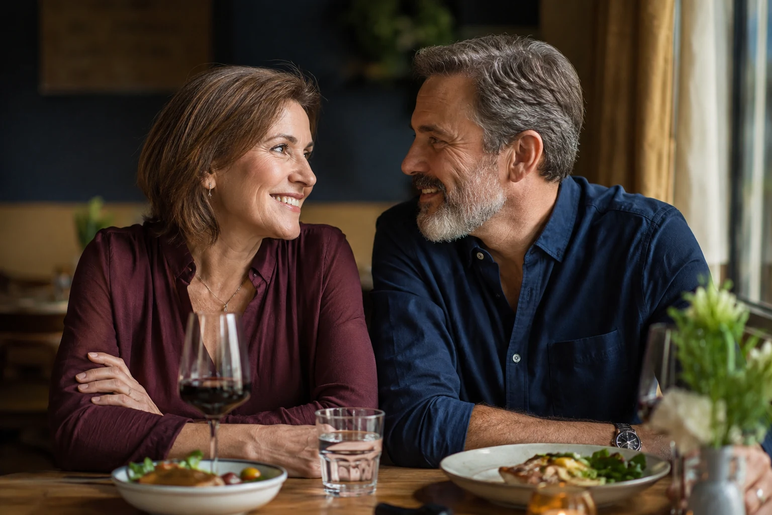 A couple enjoying conversation across a restaurant table