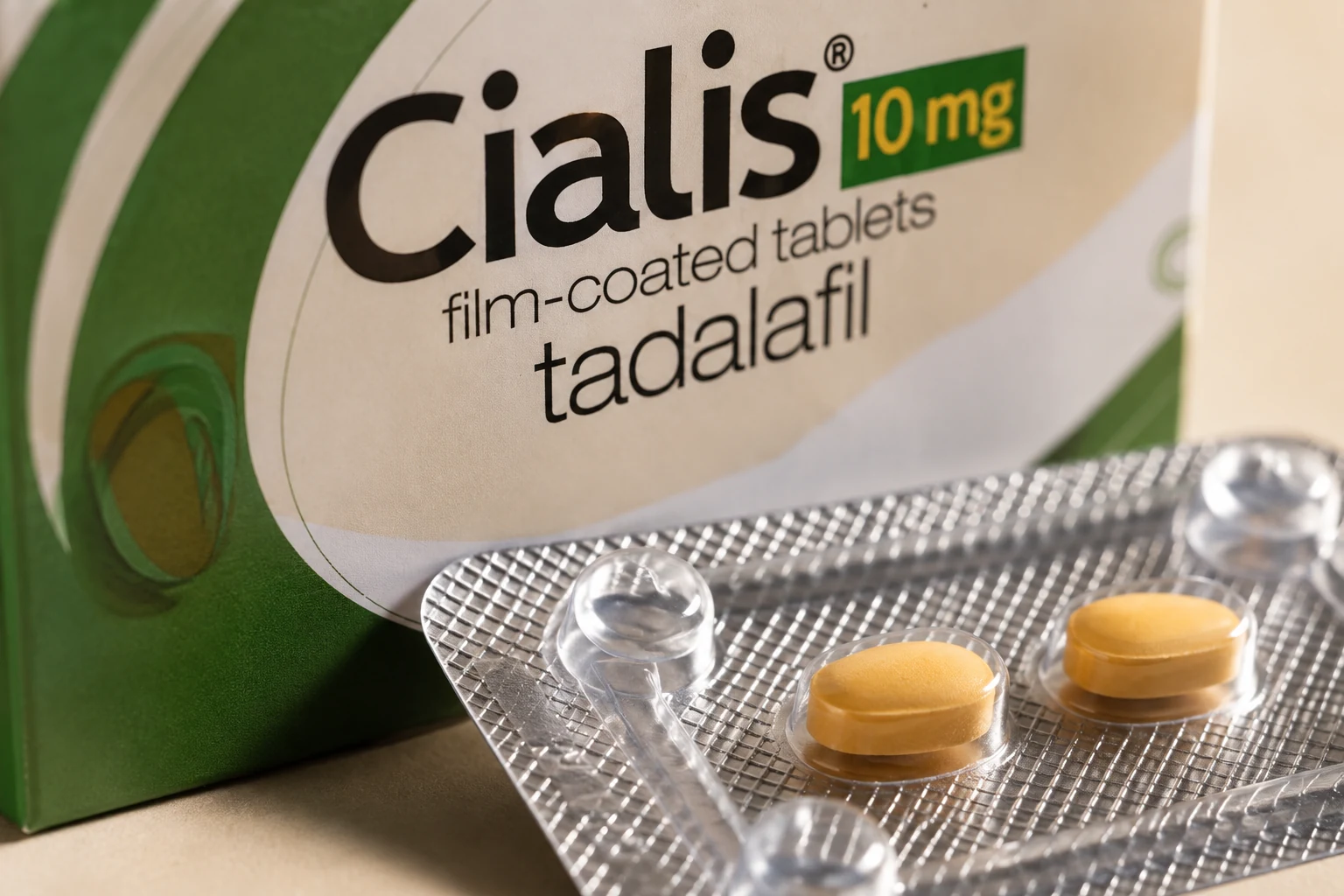 Close view of a silver tablet blister beside Cialis packaging labelled tadalafil 10 mg