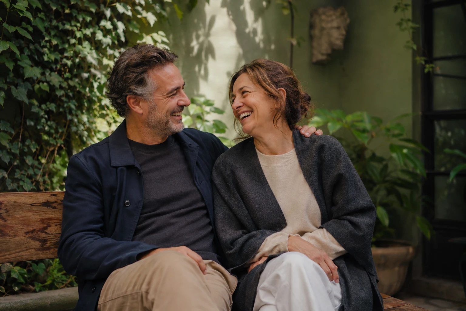 Adult couple sharing a relaxed moment on a garden bench
