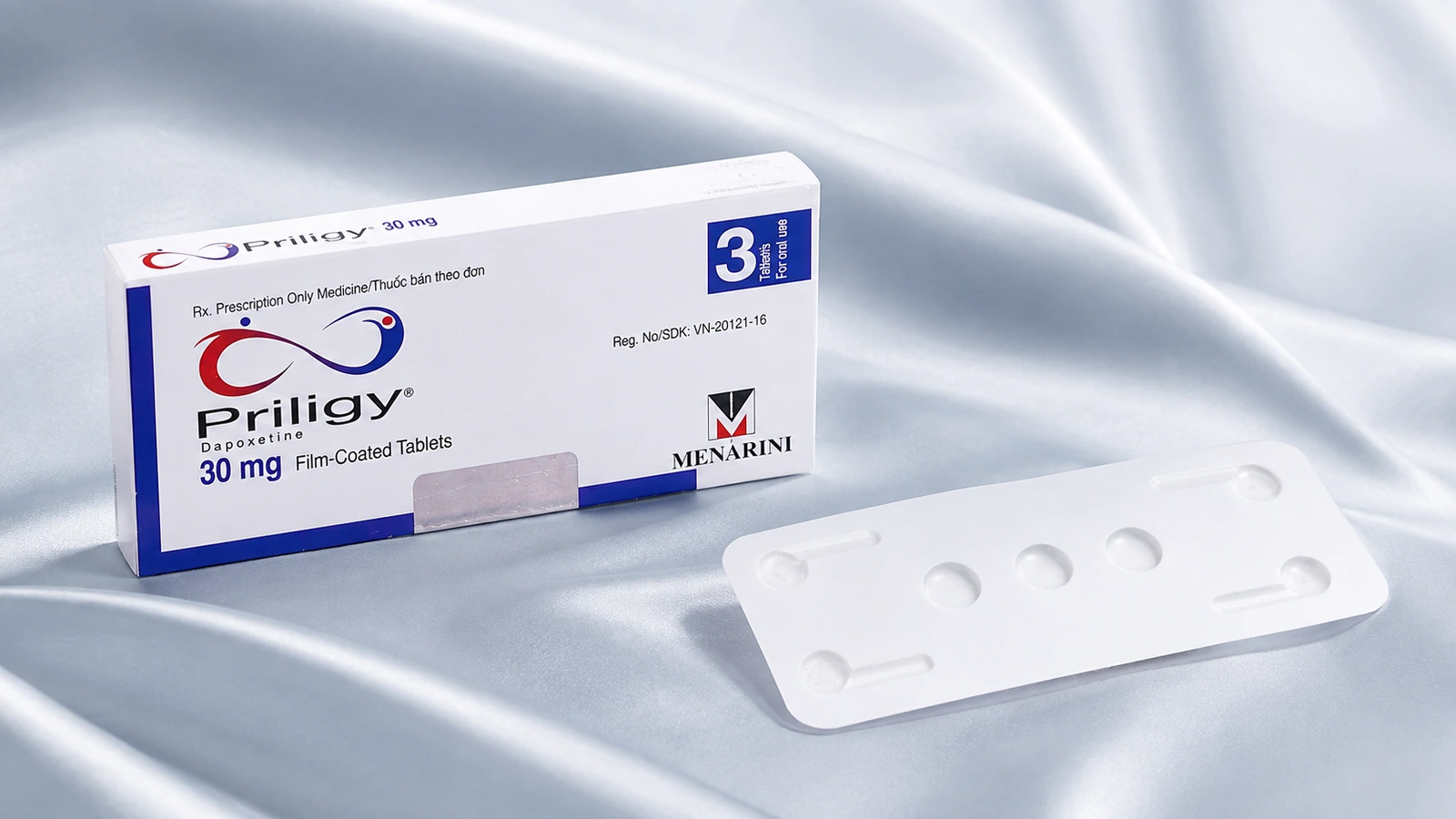 Priligy 30 mg carton and blister on a blue studio surface